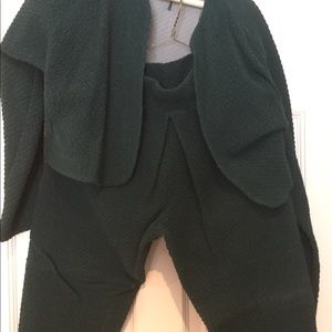 Pant outfit with stirrups and pleats . Bolero jacket